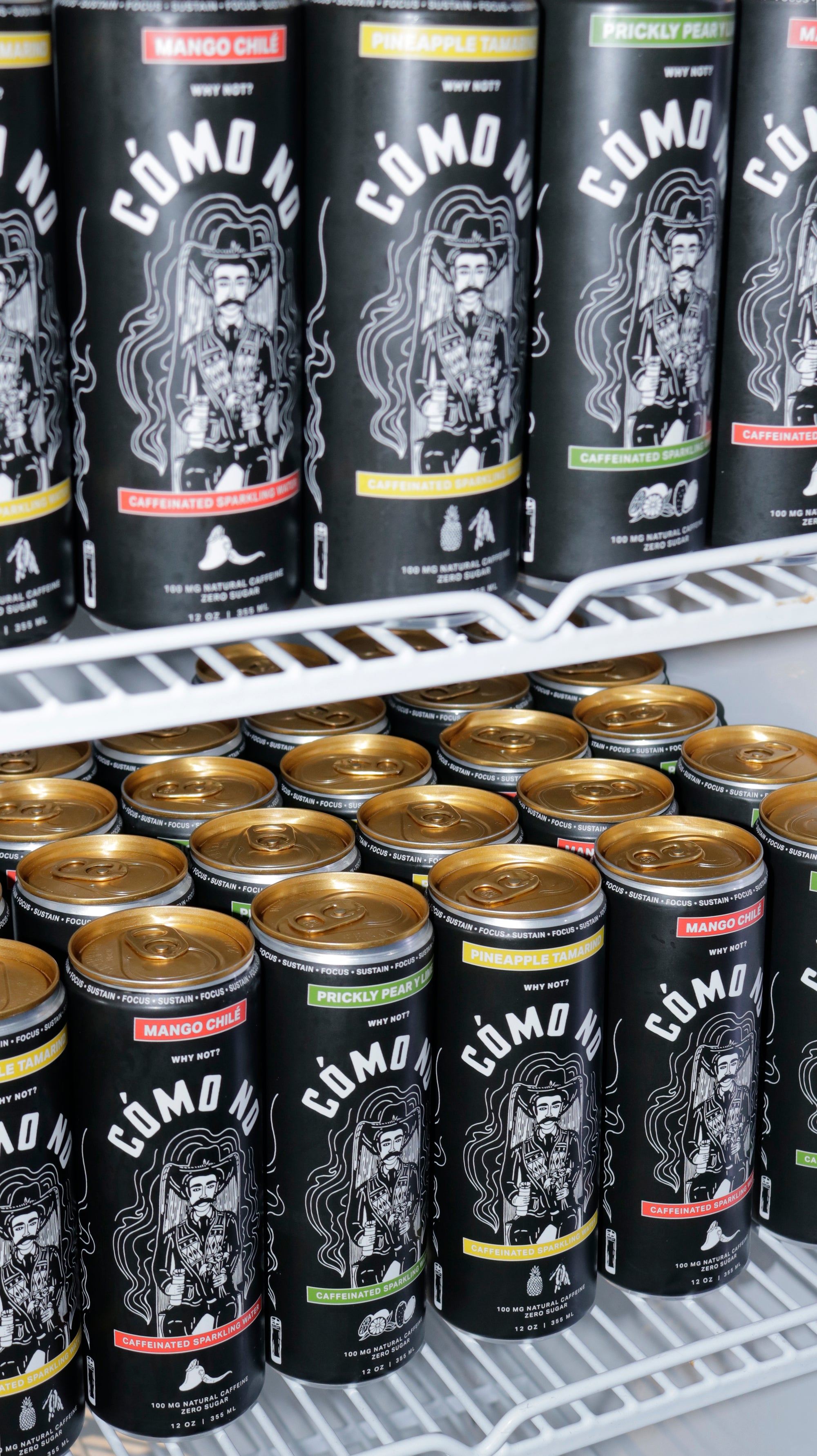 12 Pack Mixed Flavors Como No energy drinks in black cans displayed on refrigerator shelves showing variety of flavors