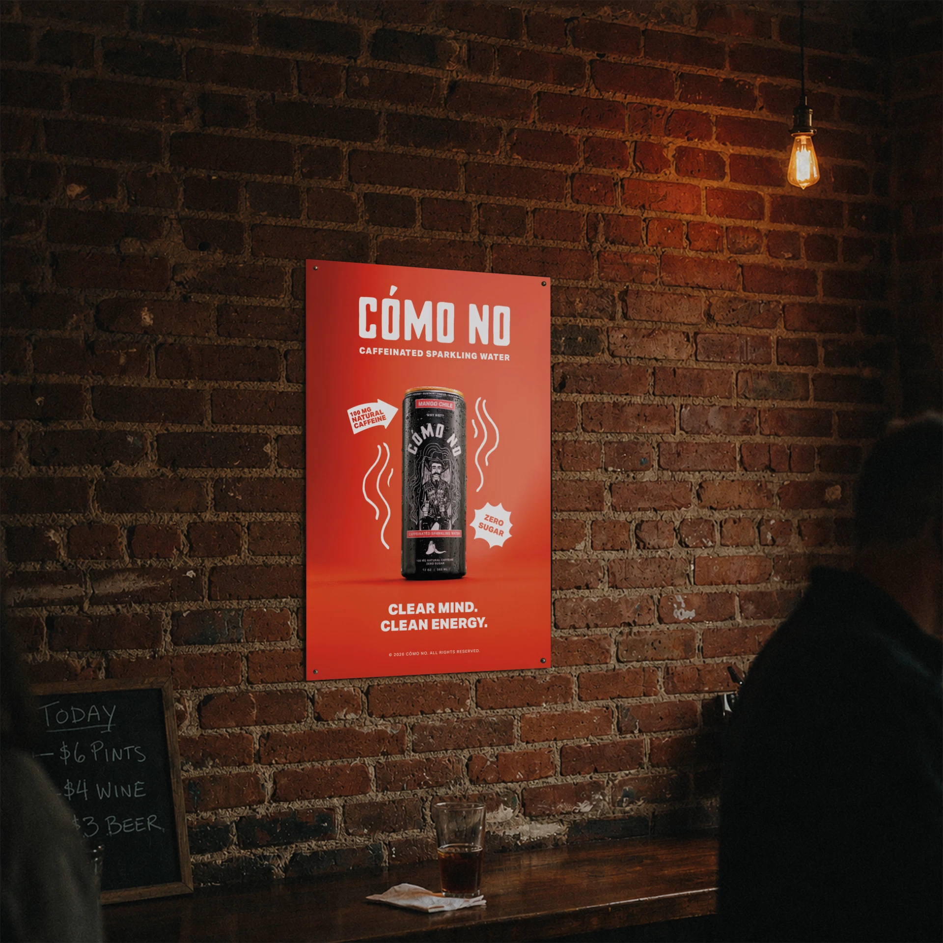 Cómo No Mango Chile poster mockup hanging on a brick bar wall